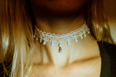 Midsection of woman wearing choker