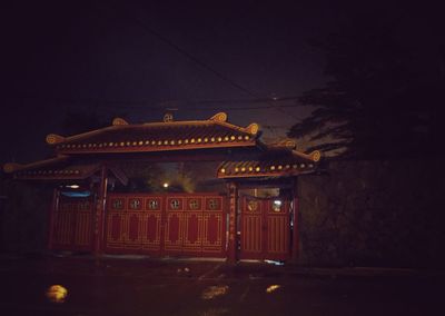 Illuminated building against sky at night