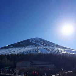 Sun shining over snowcapped mountains