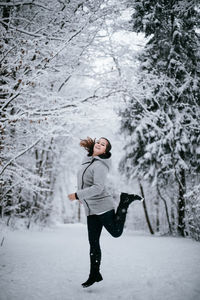 Full length of woman on snow covered field