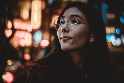 Close-up portrait of young woman looking away