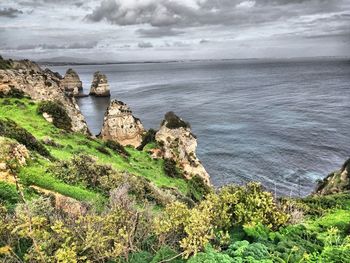 Scenic view of sea against cloudy sky