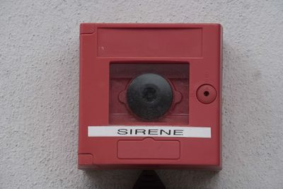 Close-up of red mailbox on wall