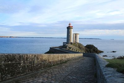 Lighthouse by sea against sky in france