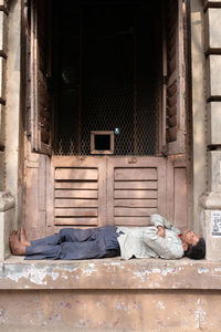 Man sleeping outside house