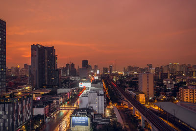 High angle view of illuminated buildings against sky during sunset