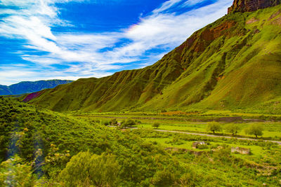 Scenic view of mountain against cloudy sky