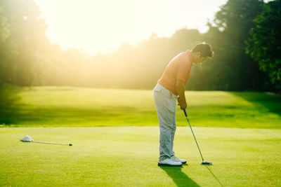 Man playing with ball on golf course