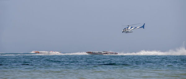 Boat sailing in sea against clear sky