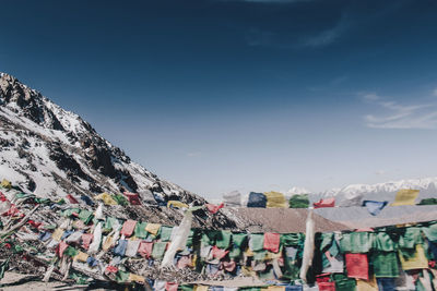 Low angle view of buddhist flags hanging against sky