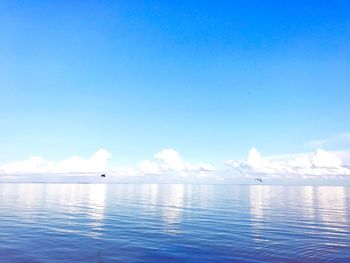 Scenic view of sea against blue sky