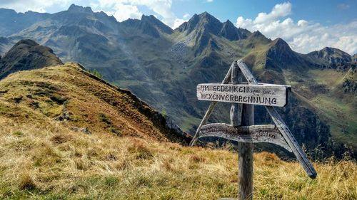 Information sign on landscape against sky