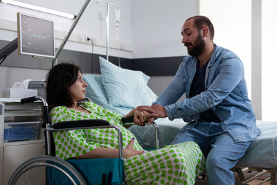 Portrait of female doctor examining patient at home