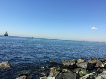 Scenic view of sea against clear blue sky