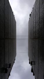 Low angle view of buildings against cloudy sky