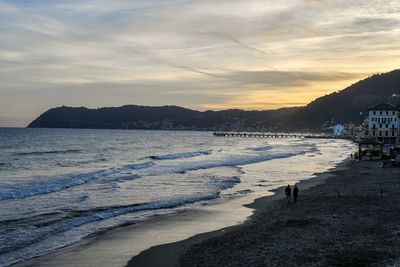 Scenic view of beach against sky during sunset