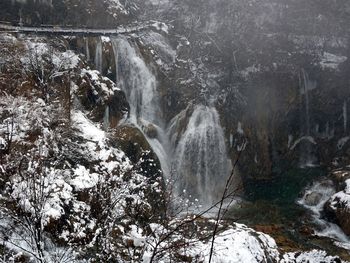 Low angle view of waterfall against sky