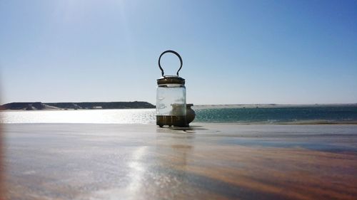 Lifeguard hut on beach against clear sky