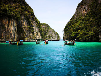 Scenic view of boats in sea against sky