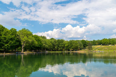 Scenic view of lake by trees against sky