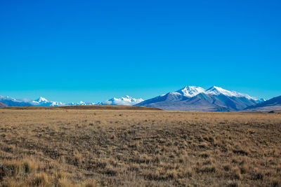 Scenic view of snowcapped mountains against clear blue sky