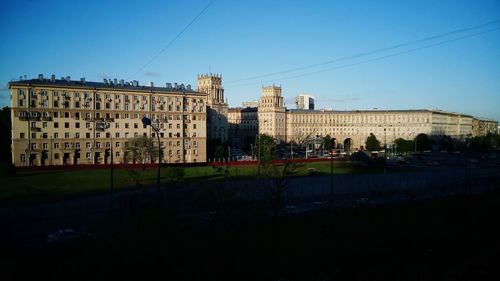 Buildings in city against clear sky