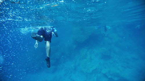 Man swimming underwater in sea