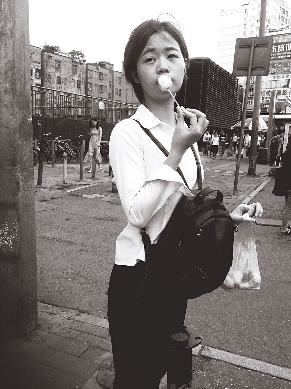 VIEW OF GIRL STANDING IN CITY