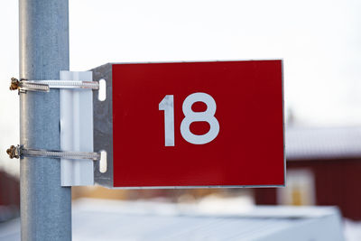 Close-up of warning sign on metal railing