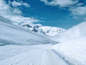 Scenic view of snow covered mountains against sky