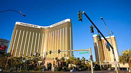 Low angle view of buildings against clear blue sky