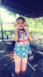 Portrait of a smiling girl standing outdoors