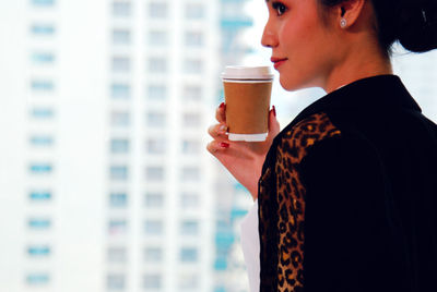 Midsection of man holding coffee cup
