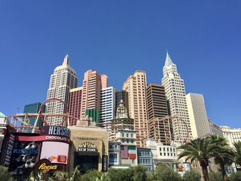 Low angle view of buildings against clear blue sky