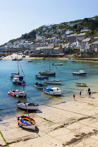 Boats moored at beach in mousehole