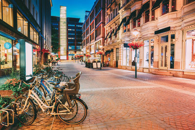 Bicycles on street amidst buildings in city