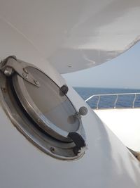 Close-up of closed window in sailboat sailing on sea