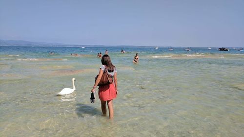 Full length of man standing on beach against sky