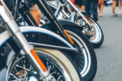 Close-up of motorcycles parked on road