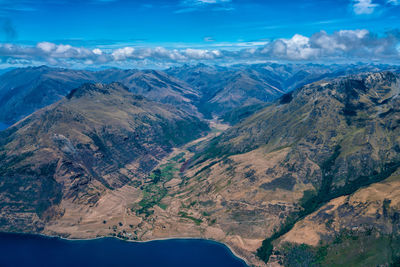 Scenic view of mountains against blue sky