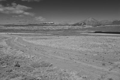 View of desert against cloudy sky