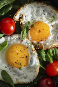 Breakfast with fried eggs and vegetables in a pan