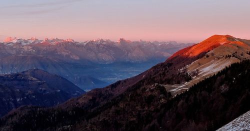 Scenic view of snowcapped mountains against sky during sunset