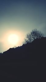 Silhouette landscape against clear sky during sunset