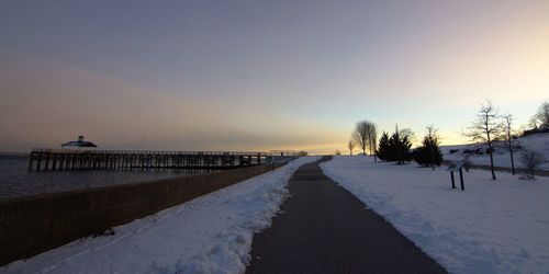 Scenic view of snow against sky during sunset