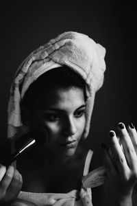 Woman applying make-up with brush