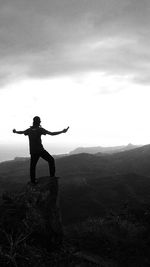 Full length of man standing on mountain against sky