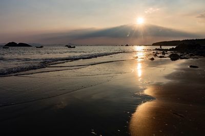 Scenic view of beach against sky during sunset