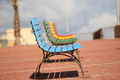 Close-up of empty chair against the sky