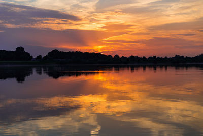 Scenic view of lake against orange sky